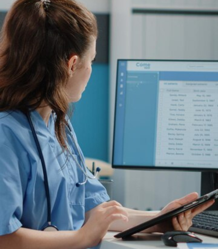 lady noting data from medical software
